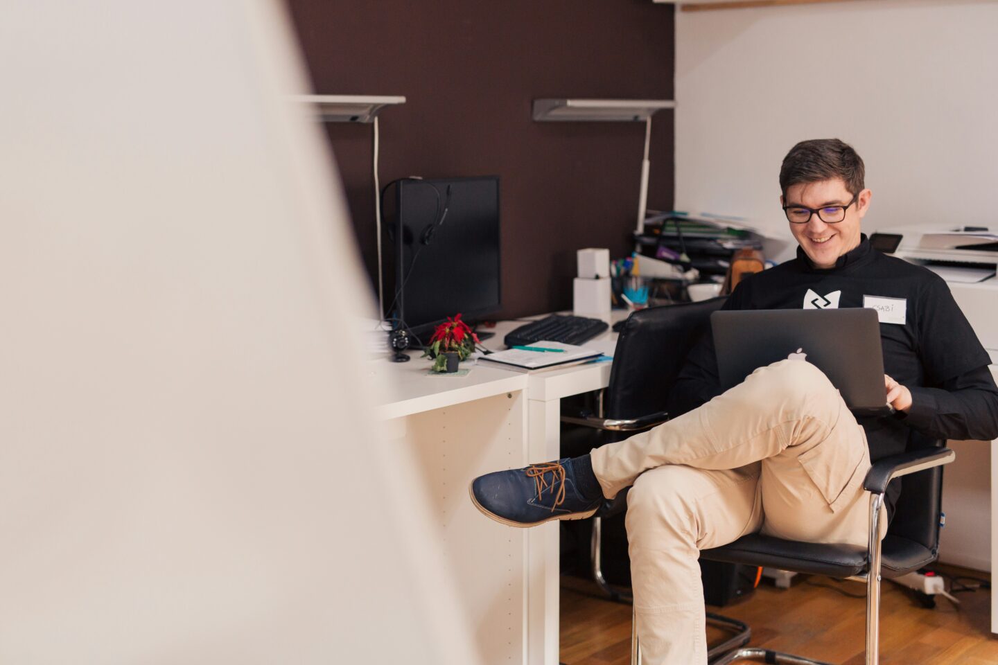 Digital freelancer in a coworking space creating a professional website and improving online presence to attract clients.