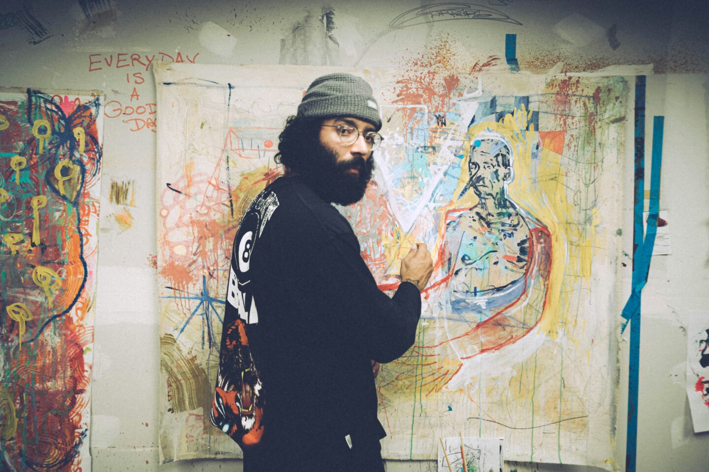 Photo of an artist painting on a canvas